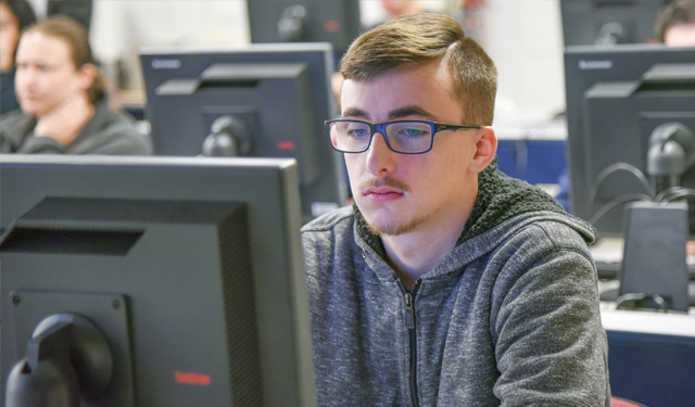 Student in Informational Technology Program and Cyber Security Information Technology Classroom Photo